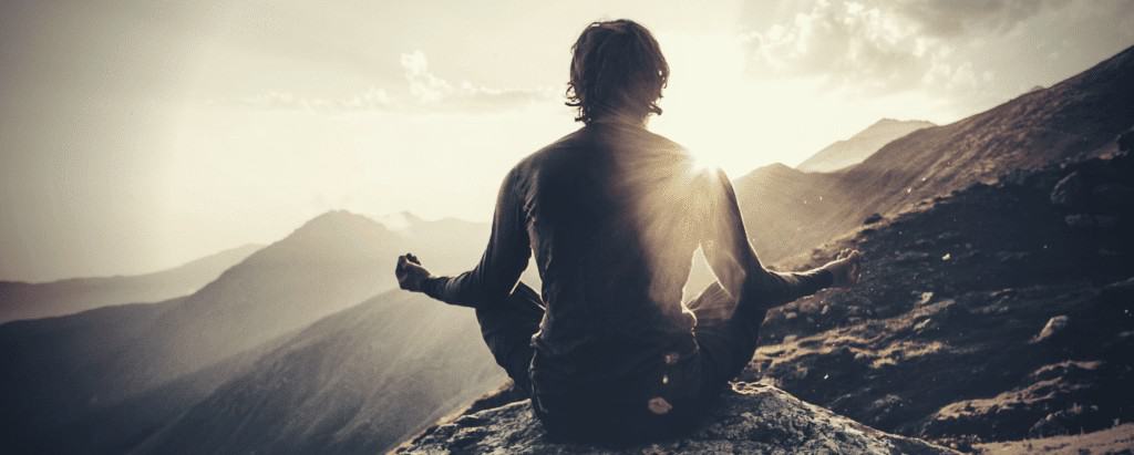 man meditating in mountain on masculinity
