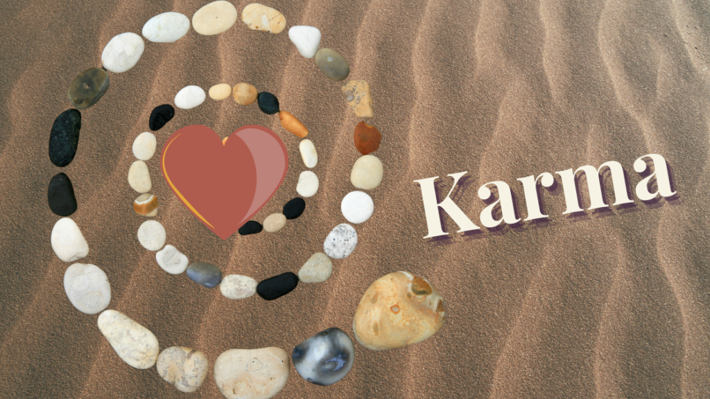 spiral of rocks in sand with the words Karma and a heart
